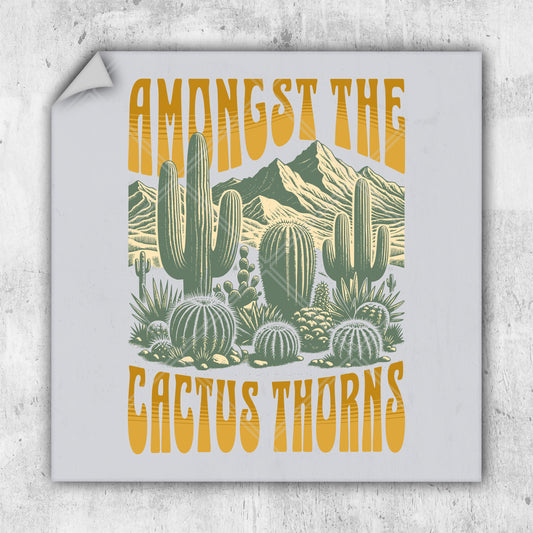 a sticker that says, among the cactus thorns