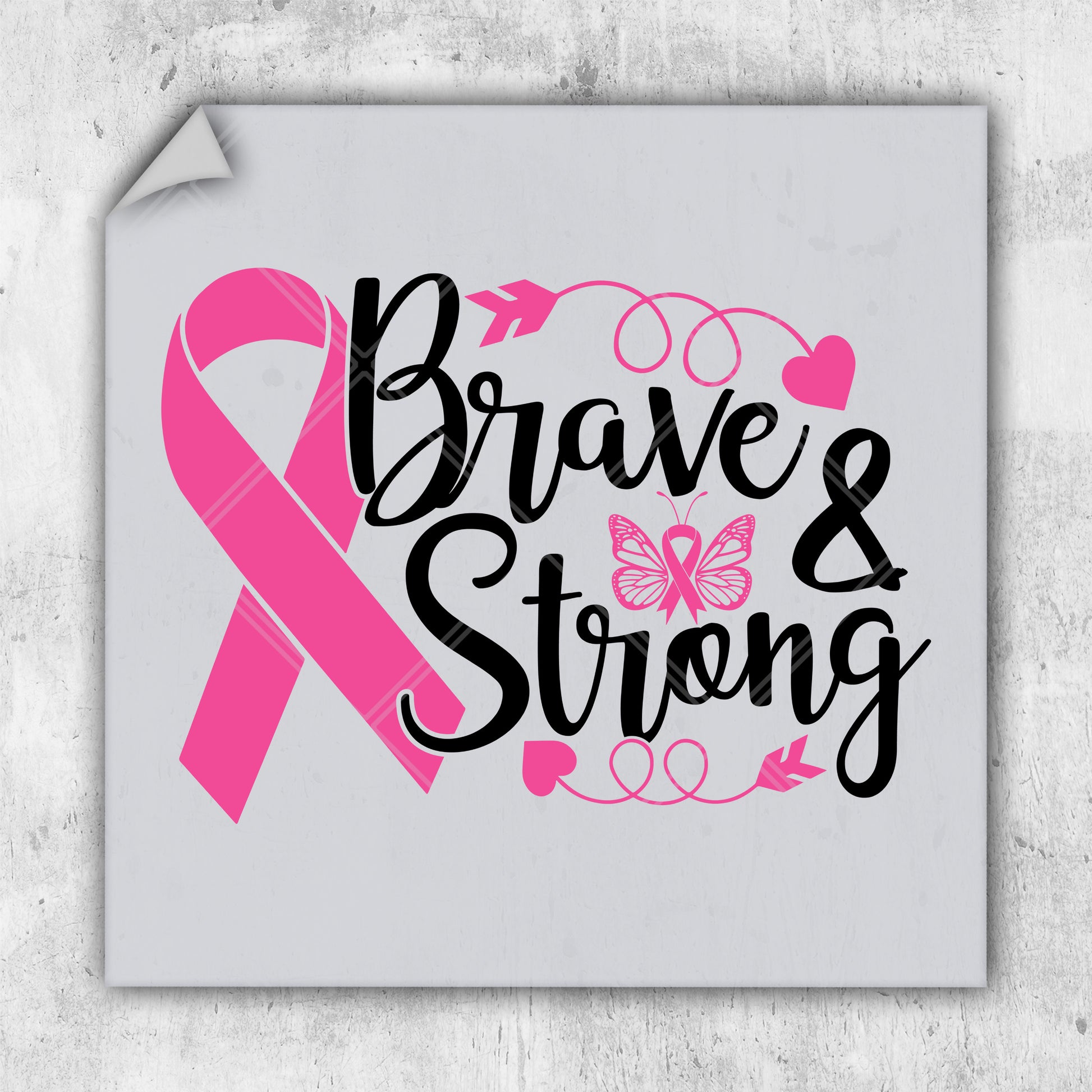 a pink ribbon with the words brave and strong